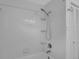 Bathroom bathtub with white tile surround and showerhead; a linen closet is visible in the background at 7 Georgia Ave, Crystal Beach, FL 34681