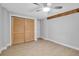 Bedroom with light floors, ceiling fan, and closet with sliding louvered doors at 7 Georgia Ave, Crystal Beach, FL 34681