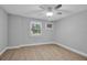 Bedroom with ceiling fan, light floors, and a window at 7 Georgia Ave, Crystal Beach, FL 34681