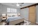 Stylishly decorated bedroom with modern artwork and a sliding barn door accent at 7 Georgia Ave, Crystal Beach, FL 34681