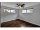 Comfortable bedroom with wood floors, modern ceiling fan, and natural light at 7 Georgia Ave, Crystal Beach, FL 34681