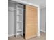 Open closet with light wood sliding door and built-in shelving at 7 Georgia Ave, Crystal Beach, FL 34681