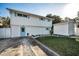 Charming two-story home with blue trim, a green lawn and a convenient storage shed at 7 Georgia Ave, Crystal Beach, FL 34681