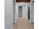Hallway with wood-like flooring and multiple doors at 7 Georgia Ave, Crystal Beach, FL 34681