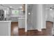 Bright kitchen features white cabinets, stainless steel appliances, and staircase access at 7 Georgia Ave, Crystal Beach, FL 34681