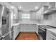 Bright kitchen with stainless steel appliances, modern cabinets, and hardwood floors at 7 Georgia Ave, Crystal Beach, FL 34681