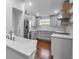 Bright kitchen featuring stainless steel appliances, custom cabinets, and hardwood floors at 7 Georgia Ave, Crystal Beach, FL 34681