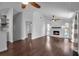 Spacious living room boasts dark hardwood floors, a brick fireplace, and recessed lighting at 7 Georgia Ave, Crystal Beach, FL 34681