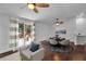 Open-concept living area with a ceiling fan and sliding glass doors leading to a deck at 7 Georgia Ave, Crystal Beach, FL 34681