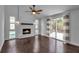 Bright living room featuring a painted fireplace, wood floors, and sliding glass doors to a deck at 7 Georgia Ave, Crystal Beach, FL 34681