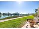 Water view from the outdoor patio featuring well manicured lawn and seating at 7465 Bay Island S Dr # 115, South Pasadena, FL 33707