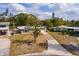 Aerial view of a residence in a verdant neighborhood, featuring a long driveway at 8001 Orient Ne Way, St Petersburg, FL 33702