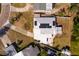 Bird's eye view of a home with a light-colored roof and solar panels surrounded by a driveway and green yard at 8001 Orient Ne Way, St Petersburg, FL 33702