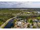 Gorgeous aerial view of a lakeside home, nestled in a green community with a city skyline beyond at 8001 Orient Ne Way, St Petersburg, FL 33702