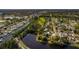 An aerial view showcases a home surrounded by a canal and lush trees in a vibrant neighborhood at 8001 Orient Ne Way, St Petersburg, FL 33702