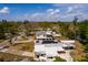An aerial view showcases a home featuring a white roof, solar panels, and a sunroom in a beautiful neighborhood at 8001 Orient Ne Way, St Petersburg, FL 33702