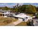Aerial view of a single-story home with solar panels and an ample driveway at 8001 Orient Ne Way, St Petersburg, FL 33702