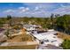 An aerial view of a house with solar panels on its roof in a residential area under a blue sky with clouds at 8001 Orient Ne Way, St Petersburg, FL 33702