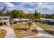 A serene neighborhood's house featuring a long driveway, seen from an aerial perspective at 8001 Orient Ne Way, St Petersburg, FL 33702