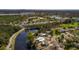 Expansive aerial view of a home next to a lake surrounded by lush greenery and other homes at 8001 Orient Ne Way, St Petersburg, FL 33702