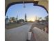 A sunny sunrise scene looking down the driveway towards the street from the front porch at 8001 Orient Ne Way, St Petersburg, FL 33702