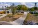 Quaint house with attached one car garage on a large grassy lot and mature landscaping at 8001 Orient Ne Way, St Petersburg, FL 33702