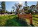 A view of Rio Vista Park in St. Petersburg featuring a wooden sign with a home visible in the background at 8001 Orient Ne Way, St Petersburg, FL 33702