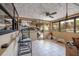 Bright sunroom with tile flooring, windows and views of the exterior of the property at 8001 Orient Ne Way, St Petersburg, FL 33702