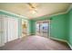 Bedroom with a door to the bathroom and sliding glass doors to a balcony with water views and a ceiling fan at 812 Point Seaside Dr, Crystal Beach, FL 34681