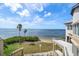 Stunning water view featuring palm trees, a sandy beach, and beautiful blue skies and open water at 812 Point Seaside Dr, Crystal Beach, FL 34681