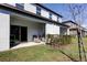 Backyard view showcasing the covered patio, barbecue grill, and lush lawn at 8294 Corner Pine Way, New Port Richey, FL 34655