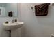 Powder room featuring a pedestal sink, mirror, and towel bar; a convenient space at 8294 Corner Pine Way, New Port Richey, FL 34655