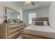 Bedroom featuring neutral walls, a window and a dresser; a peaceful retreat at 8294 Corner Pine Way, New Port Richey, FL 34655