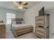Bedroom with neutral walls, ceiling fan, and a window; a serene space at 8294 Corner Pine Way, New Port Richey, FL 34655
