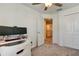 Bedroom with gray carpet, ceiling fan and a closet and doorway leading out to an open landing at 8294 Corner Pine Way, New Port Richey, FL 34655