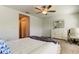 Bright bedroom featuring a ceiling fan, closet and white dresser with a large mirror at 8294 Corner Pine Way, New Port Richey, FL 34655