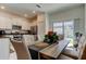 Bright dining area featuring a large table and chairs, natural light, and access to the kitchen at 8294 Corner Pine Way, New Port Richey, FL 34655
