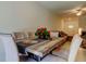 Dining room with wood table, seating for six, and adjacent living area at 8294 Corner Pine Way, New Port Richey, FL 34655