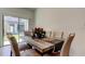 Modern dining room featuring a wood table and seating for six at 8294 Corner Pine Way, New Port Richey, FL 34655