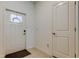 Bright entryway featuring neutral tile flooring, white walls, a decorative glass door and a coat closet at 8294 Corner Pine Way, New Port Richey, FL 34655