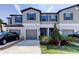 Charming townhome featuring a gray exterior, blue shutters, and well-maintained landscaping at 8294 Corner Pine Way, New Port Richey, FL 34655