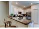 Bright kitchen boasts stainless steel appliances, granite counters, and a convenient breakfast bar at 8294 Corner Pine Way, New Port Richey, FL 34655