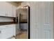 Clean kitchen with stainless steel refrigerator, white cabinets and subway tile backsplash at 8294 Corner Pine Way, New Port Richey, FL 34655