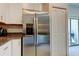 Stainless steel refrigerator and white cabinets in a modern kitchen at 8294 Corner Pine Way, New Port Richey, FL 34655