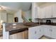 Kitchen with stainless steel dishwasher, granite countertops, and white cabinets at 8294 Corner Pine Way, New Port Richey, FL 34655