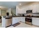 Bright kitchen with stainless steel appliances, white cabinets and granite counters at 8294 Corner Pine Way, New Port Richey, FL 34655