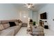 Comfortable living room featuring tile floors, a ceiling fan, and comfortable seating at 8294 Corner Pine Way, New Port Richey, FL 34655