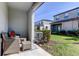 Outdoor patio with wicker furniture and a view of the lawn at 8294 Corner Pine Way, New Port Richey, FL 34655