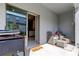 Covered outdoor patio with sliding door access to the interior, complete with outdoor seating at 8294 Corner Pine Way, New Port Richey, FL 34655