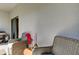 Secluded covered patio area furnished with cozy wicker chairs and a small side table at 8294 Corner Pine Way, New Port Richey, FL 34655